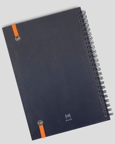 a black notebook with an orange stripe on the cover