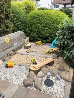 a backyard area with rocks, gravel and toys