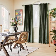 a dining room table with chairs and vases sitting on it's side in front of a window