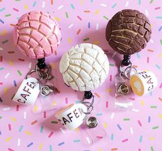 three different types of donuts on a pink background