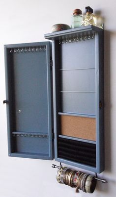 a wall mounted storage unit with several items in it