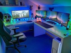 a room with three computer monitors and two keyboards on the desk in front of them