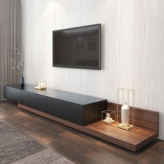 a flat screen tv mounted to the side of a wall next to a wooden shelf