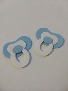 two blue and white baby pacifiers sitting next to each other