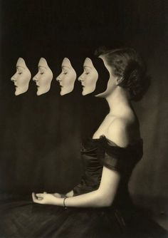 a woman sitting in front of six identical heads