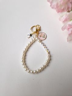 Enhance your accessory with this elegant and practical personalised wristlet bead keyring. This custom name bag tag, perfect for school bags, car keys, or handbags, is not just a stylish statement but a functional piece designed to keep your essentials within reach. Made from high-quality materials, this key ring bracelet combines aesthetics with durability. White Beaded Keychains For Everyday Use, White Round Beads Keychains For Everyday Use, White Bag Charm Keychain As A Gift, White Bag Charm Keychain Gift, White Wristlet With Keychain As Gift, Handmade White Jewelry For School, Customized White Keychains For Everyday Use, Handmade White Keychains For Personalized Gifts, Handmade White Keychain For Personalized Gift