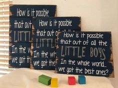 three wooden blocks sitting on top of a white table next to each other with words painted on them