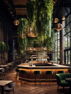 a bar with plants hanging from the ceiling and green chairs around it in front of large windows