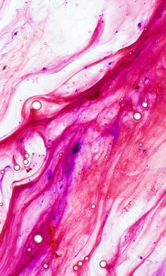 an abstract painting with pink and purple paint on it's surface, as well as bubbles