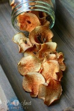 a jar filled with chips sitting on top of a wooden table