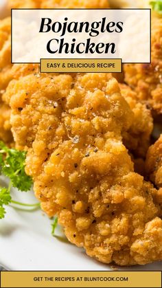 fried chicken is served on a white plate with parsley garnish and lettuce