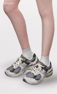 the legs and feet of a woman wearing sneakers