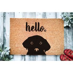 a door mat with a black dog on it