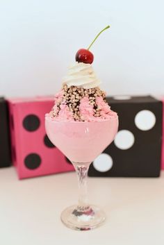 an ice cream sundae with sprinkles and a cherry on the top