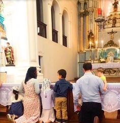 a group of people standing in front of a church alter