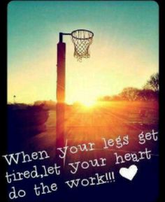 a basketball hoop with the sun setting in the background and an inspirational quote written on it