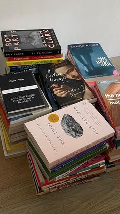 a stack of books sitting on top of a wooden table