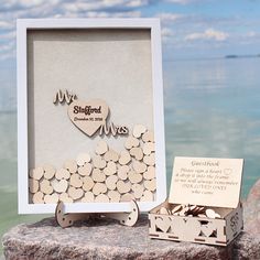 a couple of wooden pieces sitting on top of a rock next to a box filled with hearts