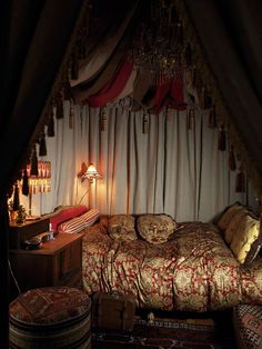 a bed sitting under a canopy in a bedroom