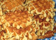 several waffles are arranged on a blue and white checkered tablecloth, ready to be eaten