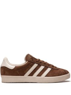 coffee brown/cream white calf leather panelled design contrast stitching signature 3-Stripes logo signature trefoil logo detail appliqué lettering logo-embossed tongue branded heel counter round toe front lace-up fastening branded insole flat rubber sole Men’s Fall Shoes 2024, Brown Gazelle, Mens Sneakers Fashion, Brown Shoes Men, Sneakers Brown, Lettering Logo, Adidas Originals Mens, Brown Shoes, Brown Sneakers