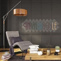 a living room with a chair, lamp and books on the table in front of it