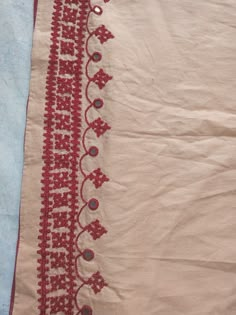 a piece of cloth with red and white designs on it