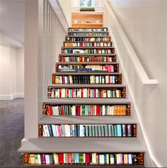 there is a stair case with many books on it