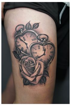 a woman's thigh with a rose and two clocks on it, all in the shape of a heart