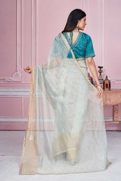 Flaunt your elegant style on festive occasions in this beautiful pastel green embroidered tissue silk saree. It comes with a beautiful green embroidered saree blouse. Disclaimer: The shown stitched blouse on the model is for display purpose only. The saree comes with a matching blouse piece and finished with fall and piko. Embroidered Saree Blouse, Tissue Silk Saree, Tussar Silk Sarees, Indian Clothing Store, Latest Designer Sarees, Embroidered Saree, Fashion Journals, Silk Saree With Blouse, Tussar Silk Saree