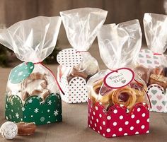 three small boxes filled with different types of cookies and pretzels on a table