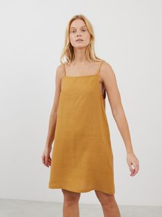 DEVON is a square neck strap mini linen dress which combines modern minimalism with a breathable fit, ideal for warm climates and summer events. Its sophisticated square neckline and a strap design make it versatile for both casual days and elegant evenings. DETAILS - Square neckline - Spaghetti straps - Mini length - 100% midweight European linen fabric - Cut and sewn to order just for you in our studio COLOR - Yellow Honey, you can also choose other colors above - Fabric samples are available Linen Mini Dress With Square Neck For Brunch, Square Neck Linen Mini Dress For Brunch, Spring Linen Mini Dress With Square Neck, Chic Linen Sundress With Adjustable Straps, Spring Square Neck Linen Mini Dress, Cotton Sundress With Square Neck Suspender, Chic Square Neck Linen Beach Dress, Spring Linen Mini Dress With Straight Neckline, Spring Mini Dress In Linen With Straight Neckline