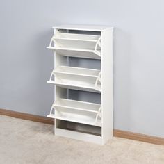 a white book shelf sitting in front of a window next to a radiator