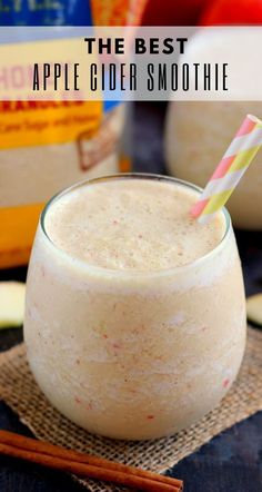 an apple cinnamon smoothie in a glass with a straw