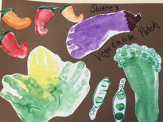 a child's drawing of vegetables and their names on a piece of brown paper