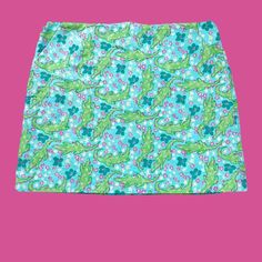 An Adorable Earlier Model Lilly Skirt -- Perfect As The Day It Was Sewn! Never Worn, Like New, Flawless Condition. Quality Corded 100% Cotton Textured Fabric, Patterned With Smooth And Crosshatch Dots Woven Across It's Surface (See Closeup). Print Is Alberta Gator -- A Whimsical Lilly Classic. It Depicts Lime Green Alligators Chasing One Another Through A Light Turquoise Marsh Filled With Deep Green Leaves And Pink, White And Palest Yellow Blossoms. Nice Tailoring And Finishing -- Two Flat Front Casual Green Mini Swim Skirt, Casual Green Lined Swim Skirt, Blue Mini Swim Skirt For Spring, Casual Green Swim Skirt For Spring, Yellow Blossom, Shipping Tags, Cotton Texture, Light Turquoise, Pale Yellow