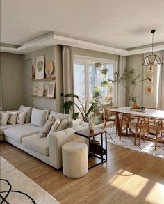 a living room filled with furniture and a dining table