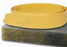 a yellow bowl sitting on top of a stone slab