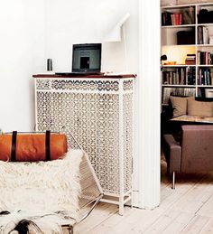 a living room with white walls and wooden floors