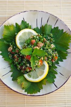 a white plate topped with lemons and greens