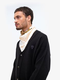 Boxy fit button-up cardigan in merino wool and cashmere, tone-on-tone embroidered logo at front, black and gold button closure, ribbed collar, cuff, and hem, and signature black leather badge at back. -Body: 70% Merino Wool / 30% Cashmere -Color: Black -Boxy Fit -Model is 6'0'' / 183cm and wears M -Care: Dry clean only -Made in Italy Luxury Black Sweater With Button Closure, Luxury Cardigan For Workwear, Luxury Fall Cardigan, Luxury Cardigan With Ribbed Cuffs, Luxury Winter Cardigan With Button Cuffs, Luxury Formal Cardigan With Button Closure, Luxury Black Cardigan For Formal Occasions, Luxury Black Formal Cardigan, Luxury Sweater With Button Closure For Formal Occasions