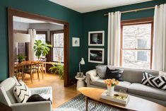 a living room filled with furniture and green walls