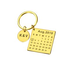 a gold keychain with the date on it