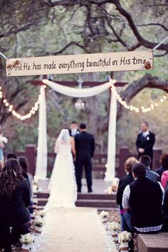 a bride and groom standing at the end of their wedding ceremony