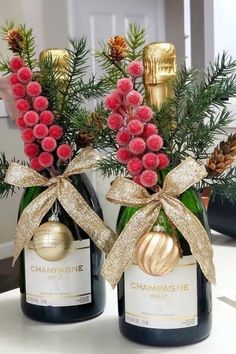 two champagne bottles with christmas decorations on them