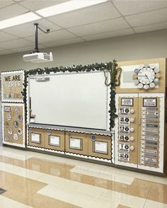 a bulletin board in the middle of a school hallway with decorations on it and an empty whiteboard