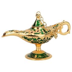 a gold and green teapot on a stand