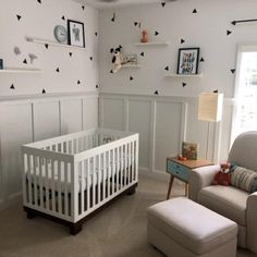 a baby's room is decorated with black and white wallpaper