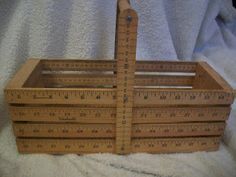 a wooden crate with measuring tape on it