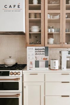 a kitchen with wooden cabinets and white counter tops is pictured in this image, there are dishes on the shelves above the stove